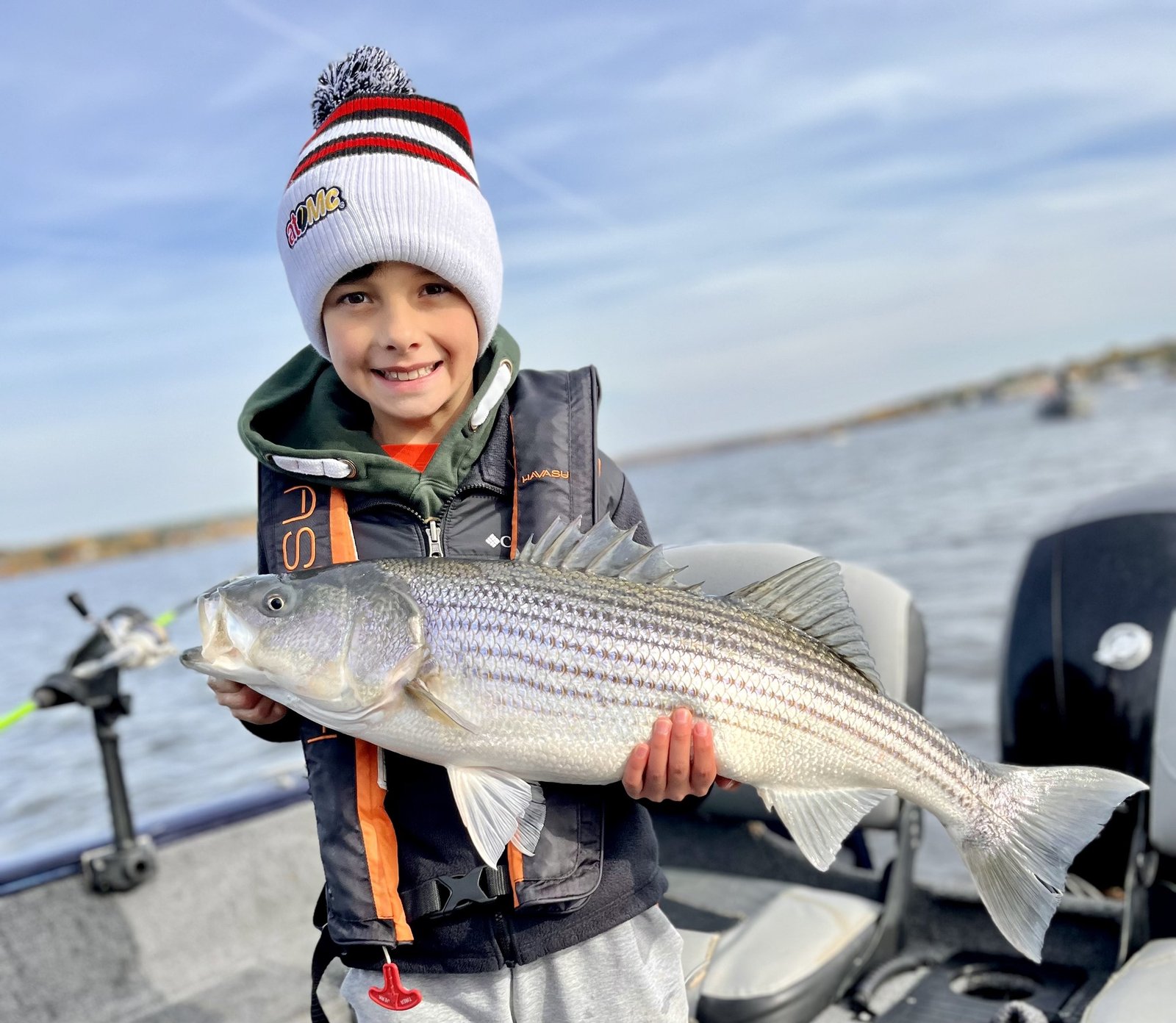 Kid with a striped bass on the Miramichi
