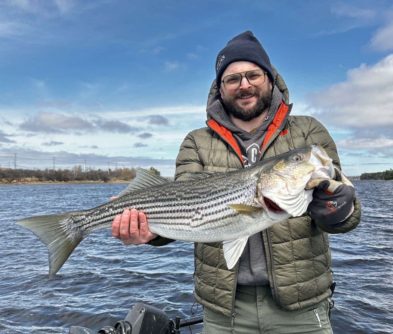 Angler with striped bass on the Miramichi River